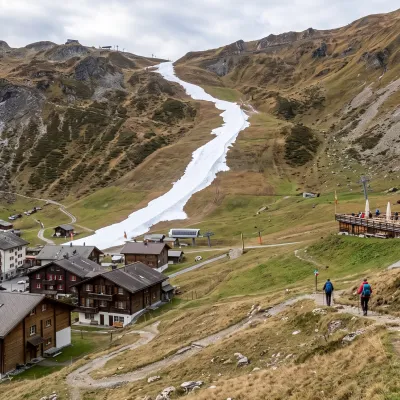 Schneearme Bergstation im Berner Oberland mit gruenen Haengen im Winter